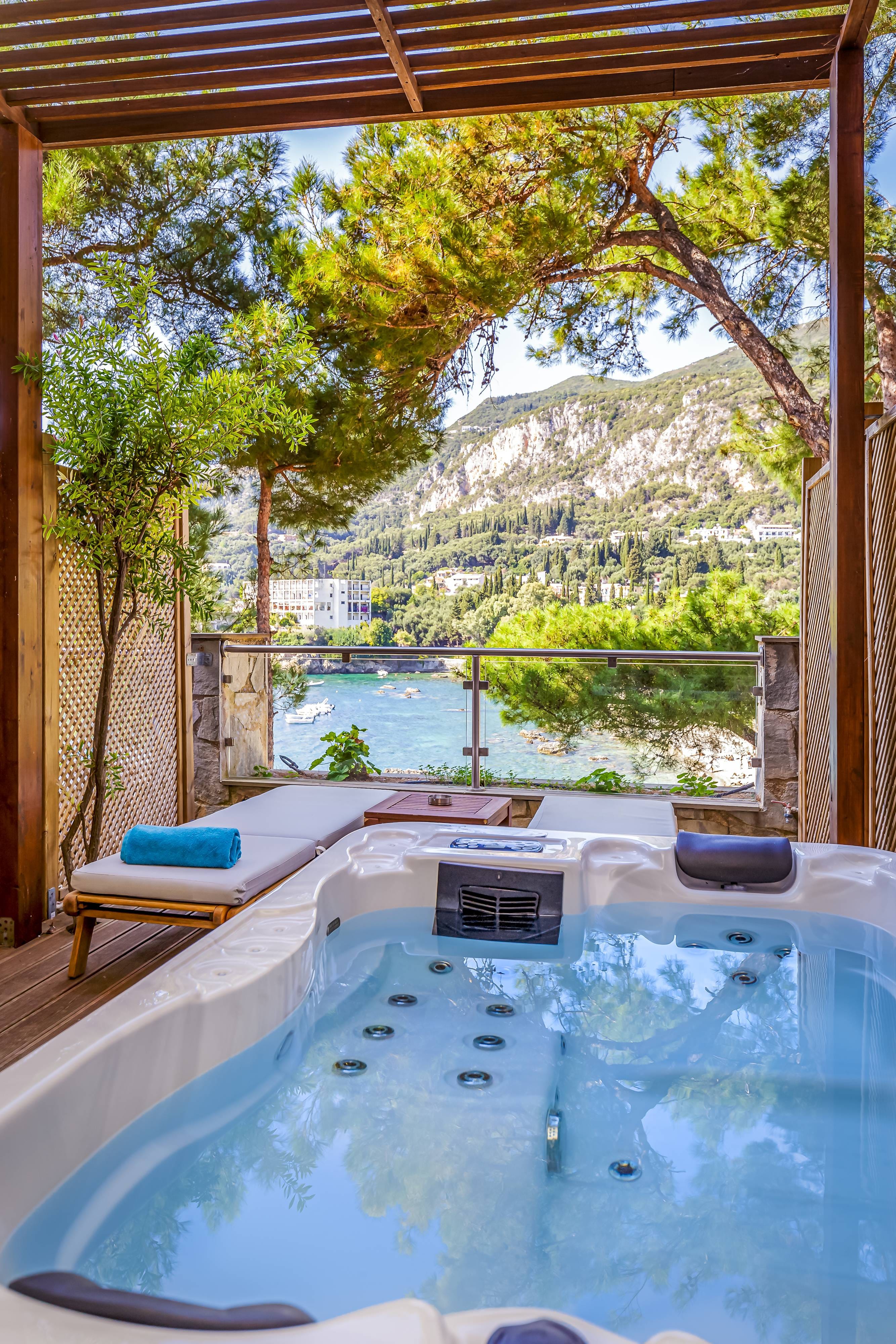 a pool with a view of a city and mountains in the background