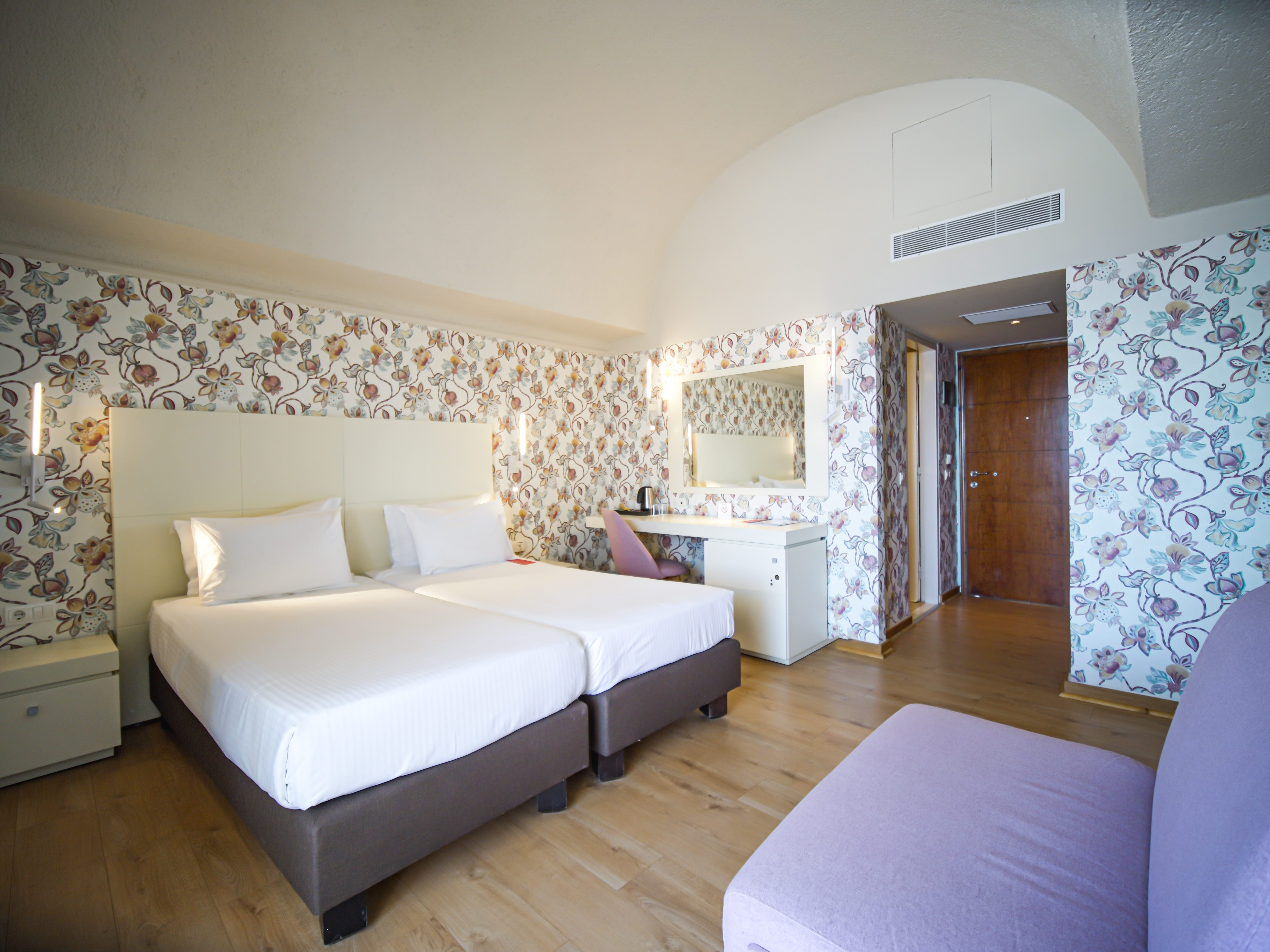 a large bedroom with a bed and a couch