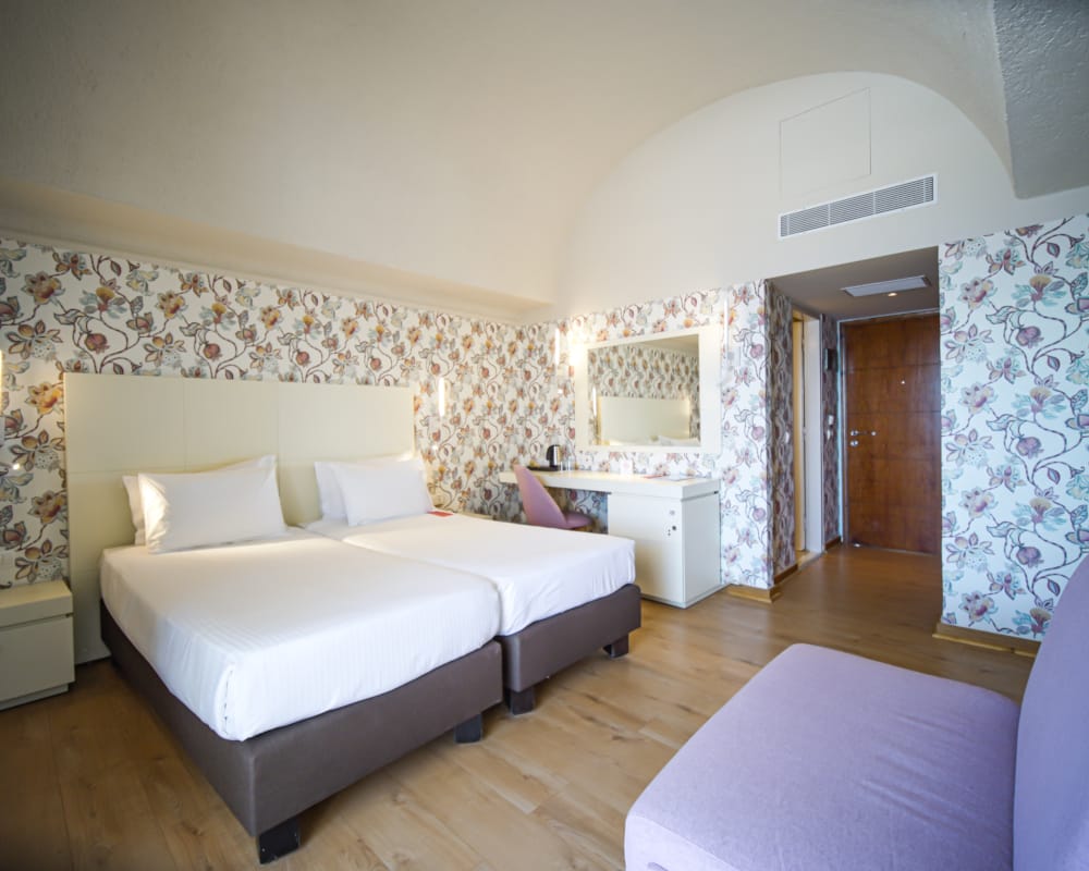 a large bedroom with a bed and a couch