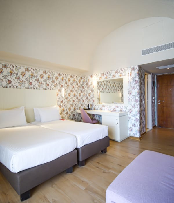 a large bedroom with a bed and a couch