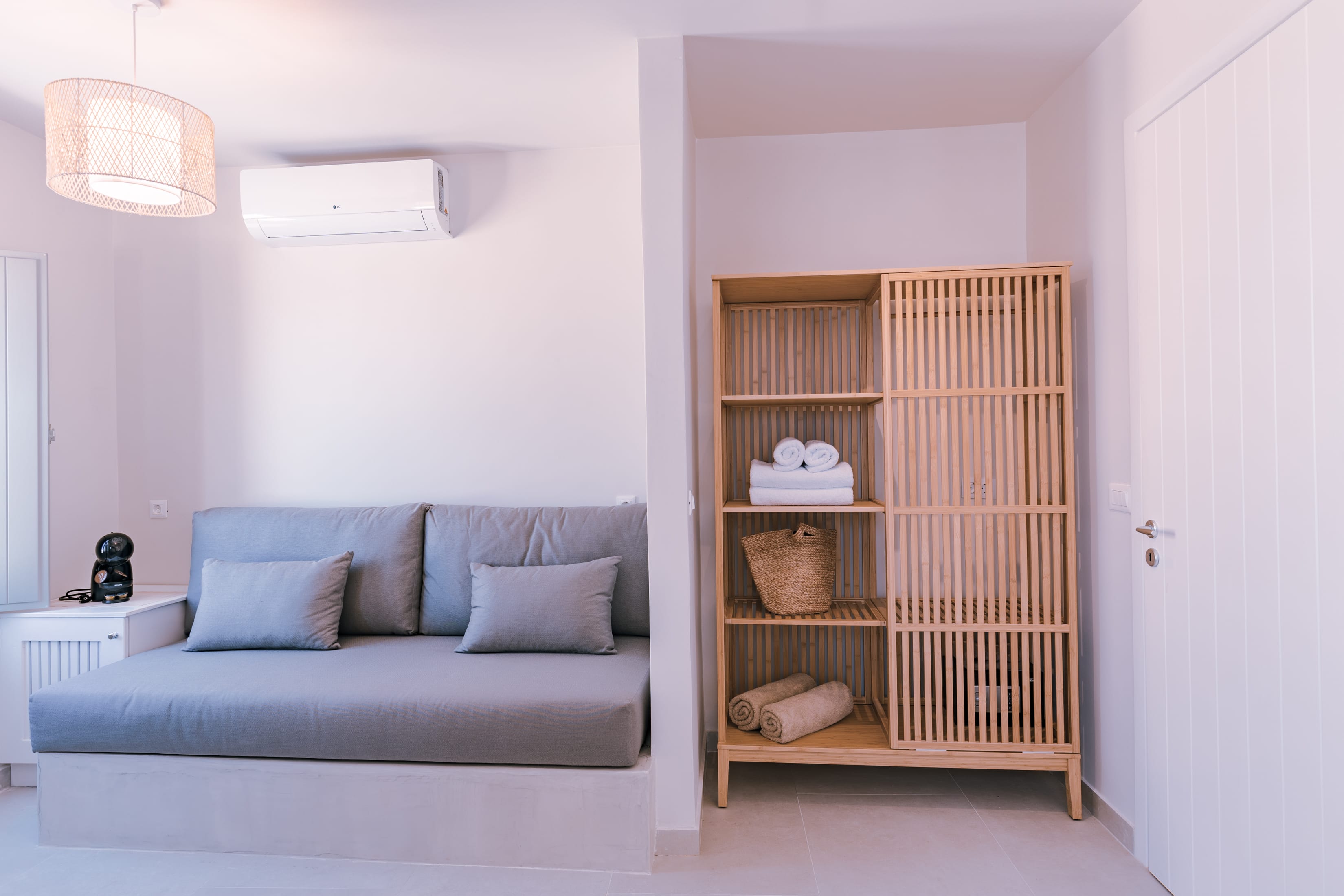 a living room with a white couch and a book shelf