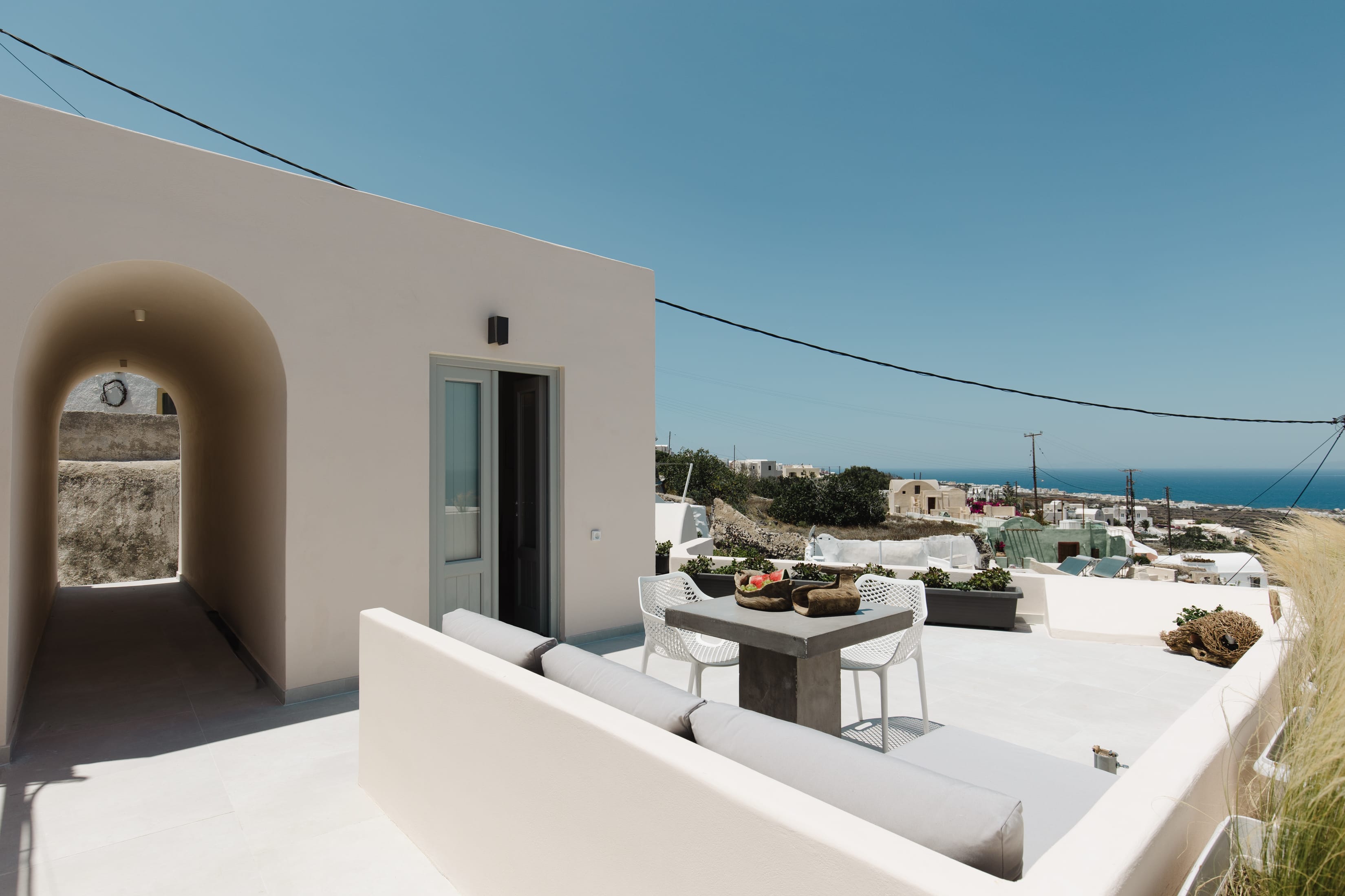 a white house with a patio and a table and chairs