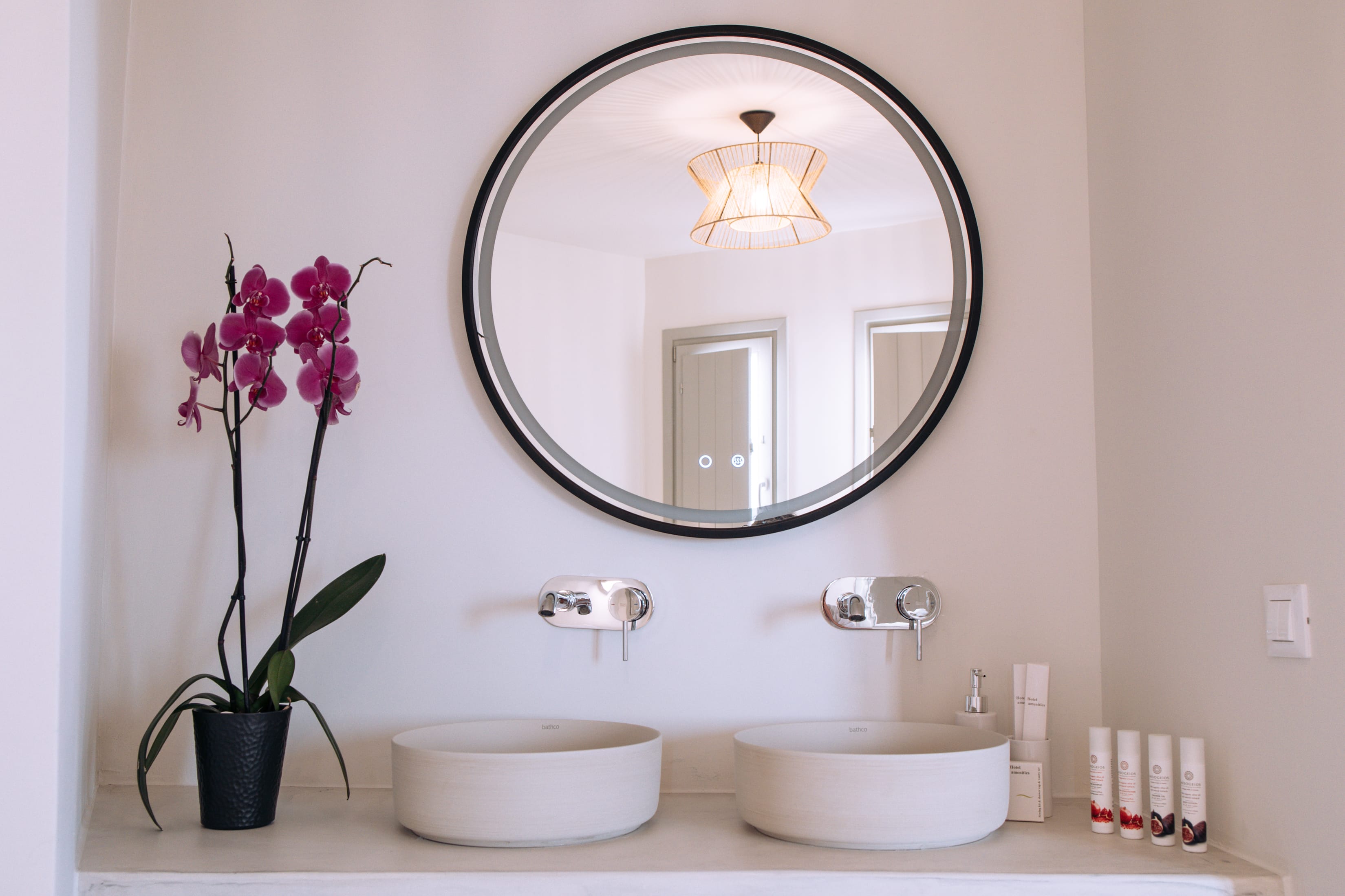 a bathroom mirror with a flower