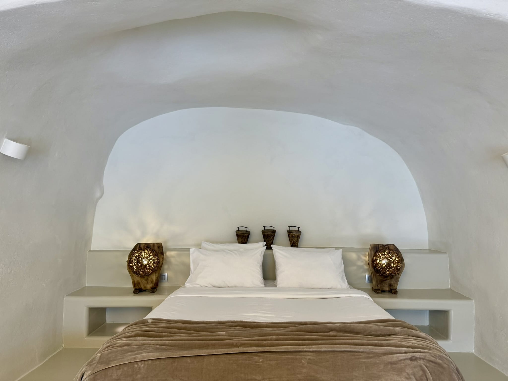 a bed with a large round pillow