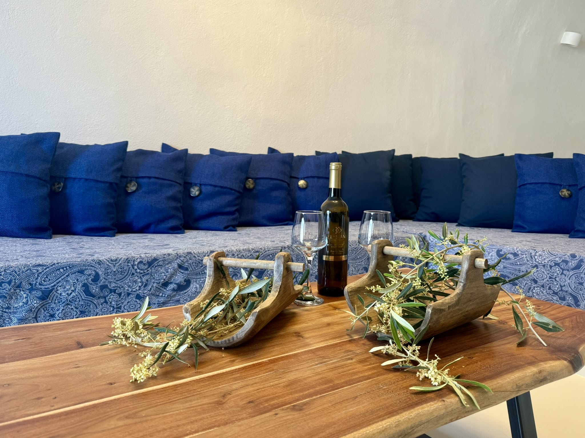 a table with a bottle and glasses on it