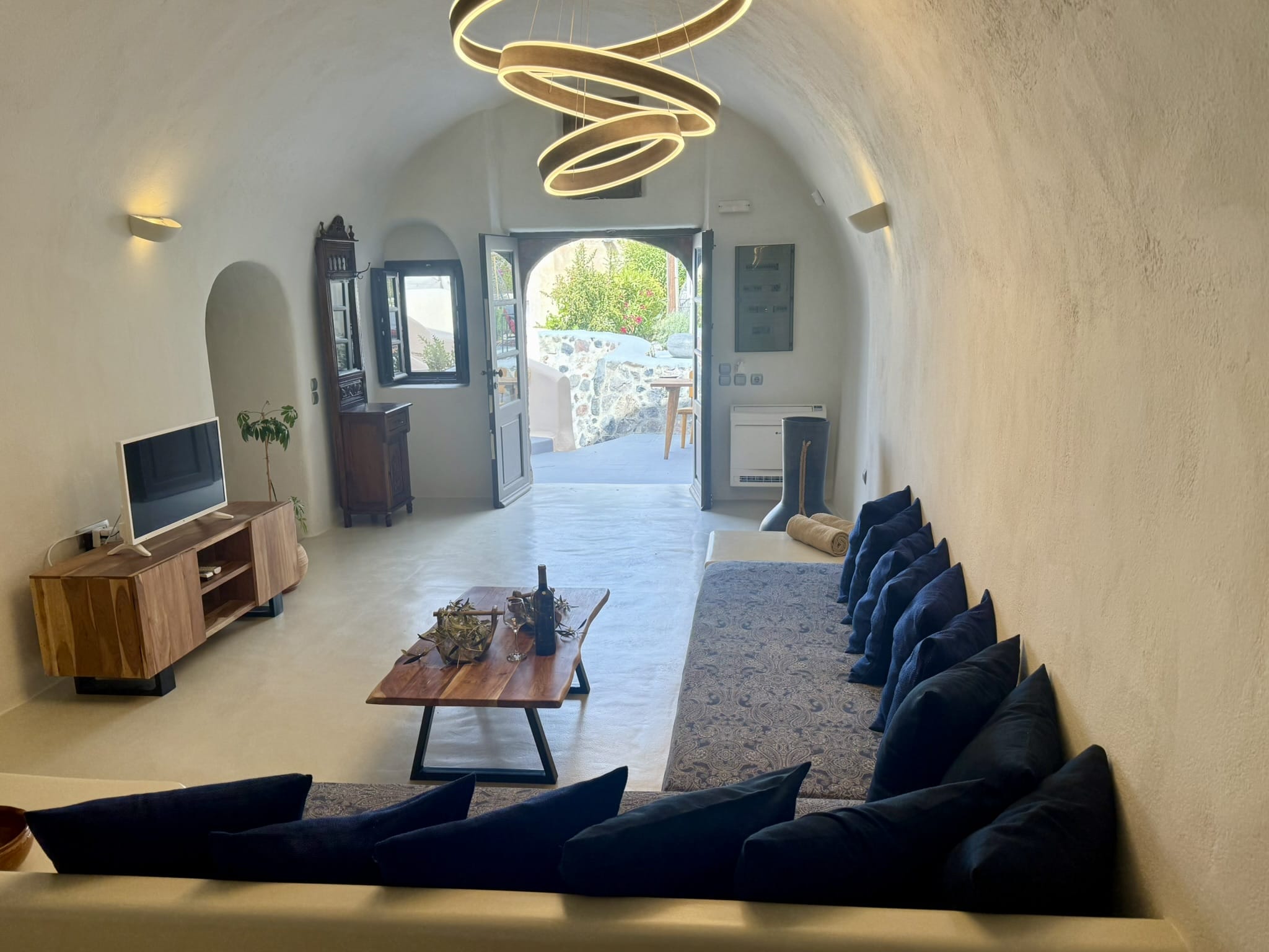 a living room with a tv and couches