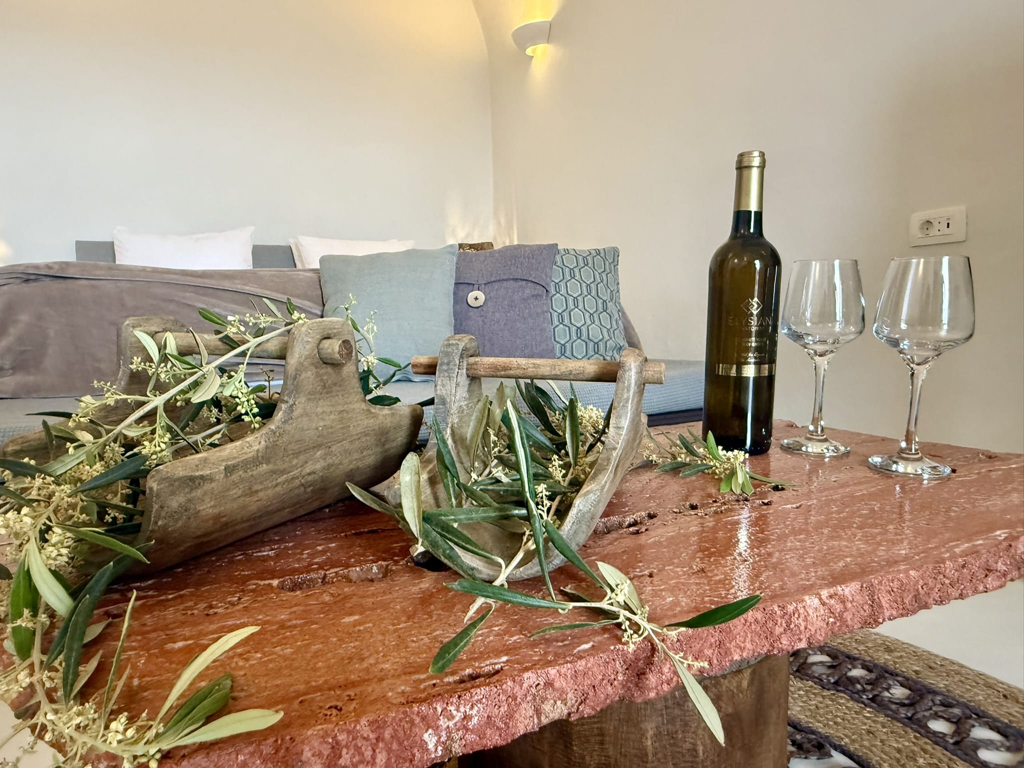 a table with wine glasses and a bottle of wine