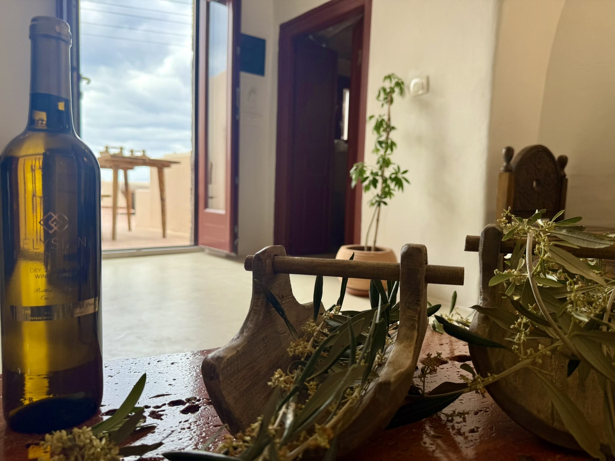 a bottle of water next to a plant and a glass bottle