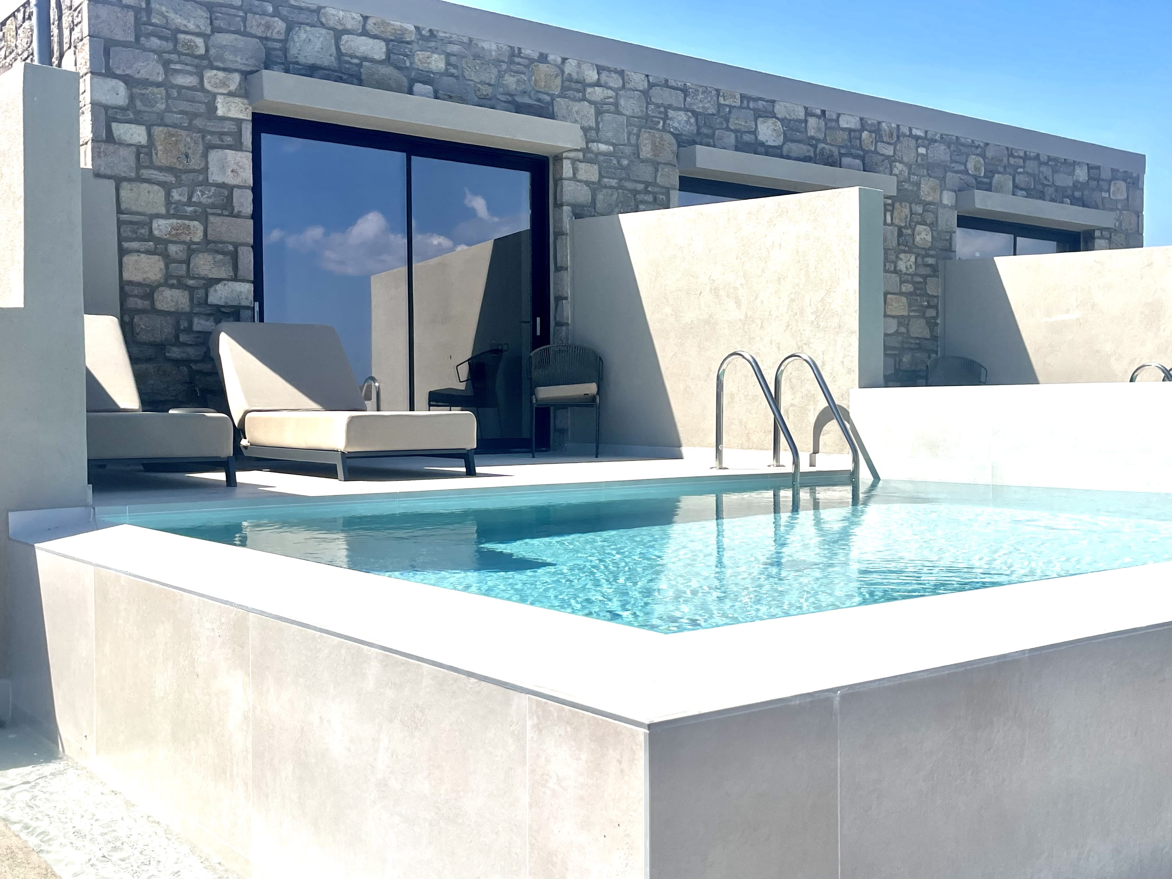 a pool with chairs around it