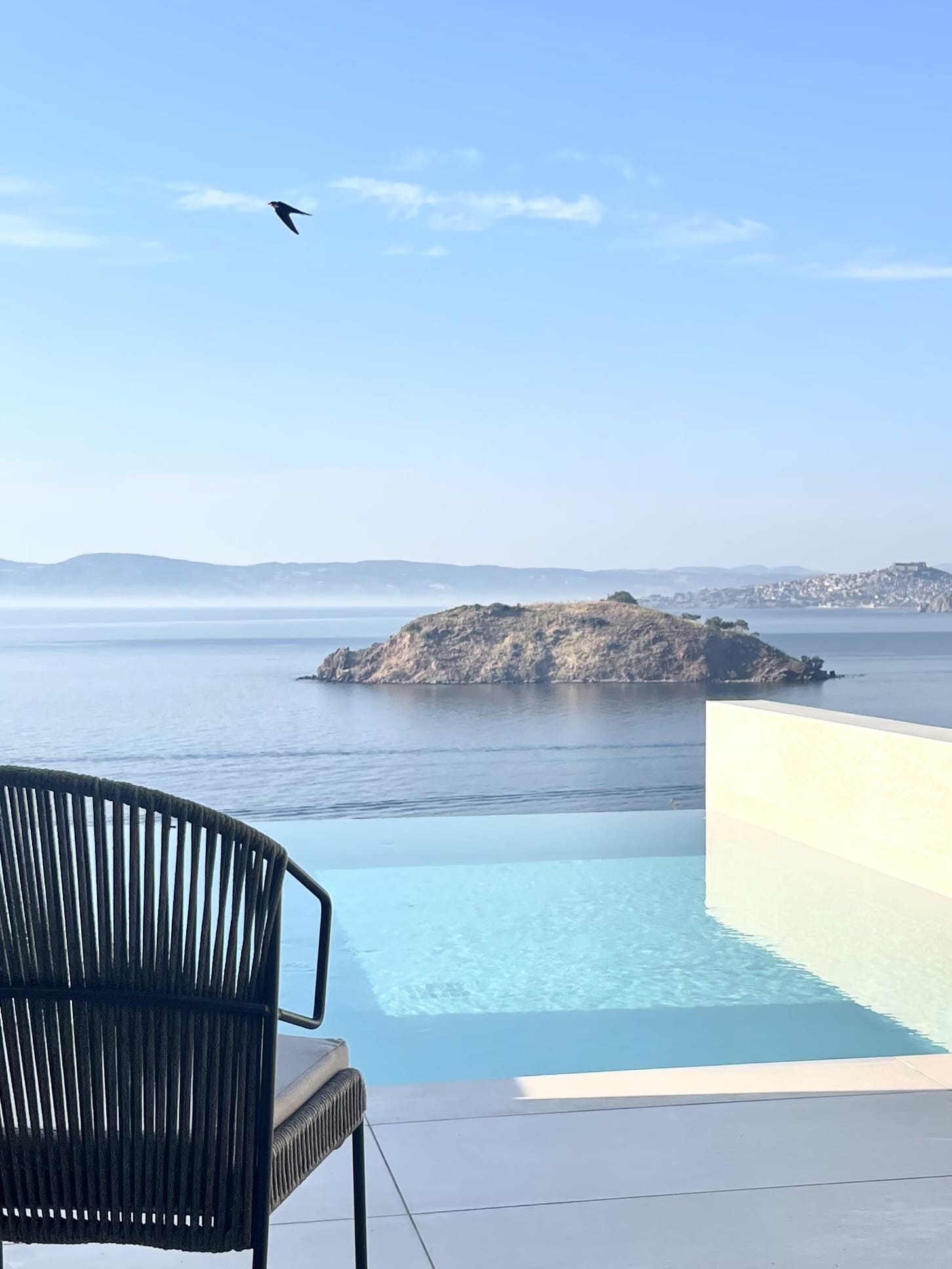 a chair on a deck overlooking a body of water