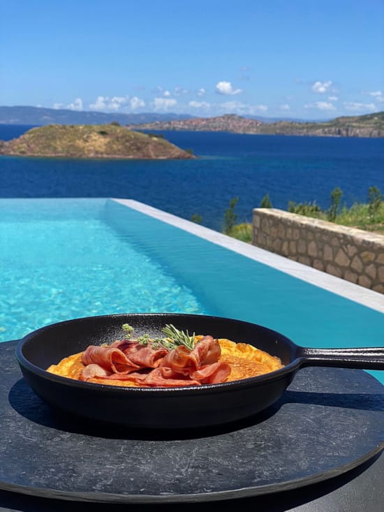 a plate of food on a table by a pool
