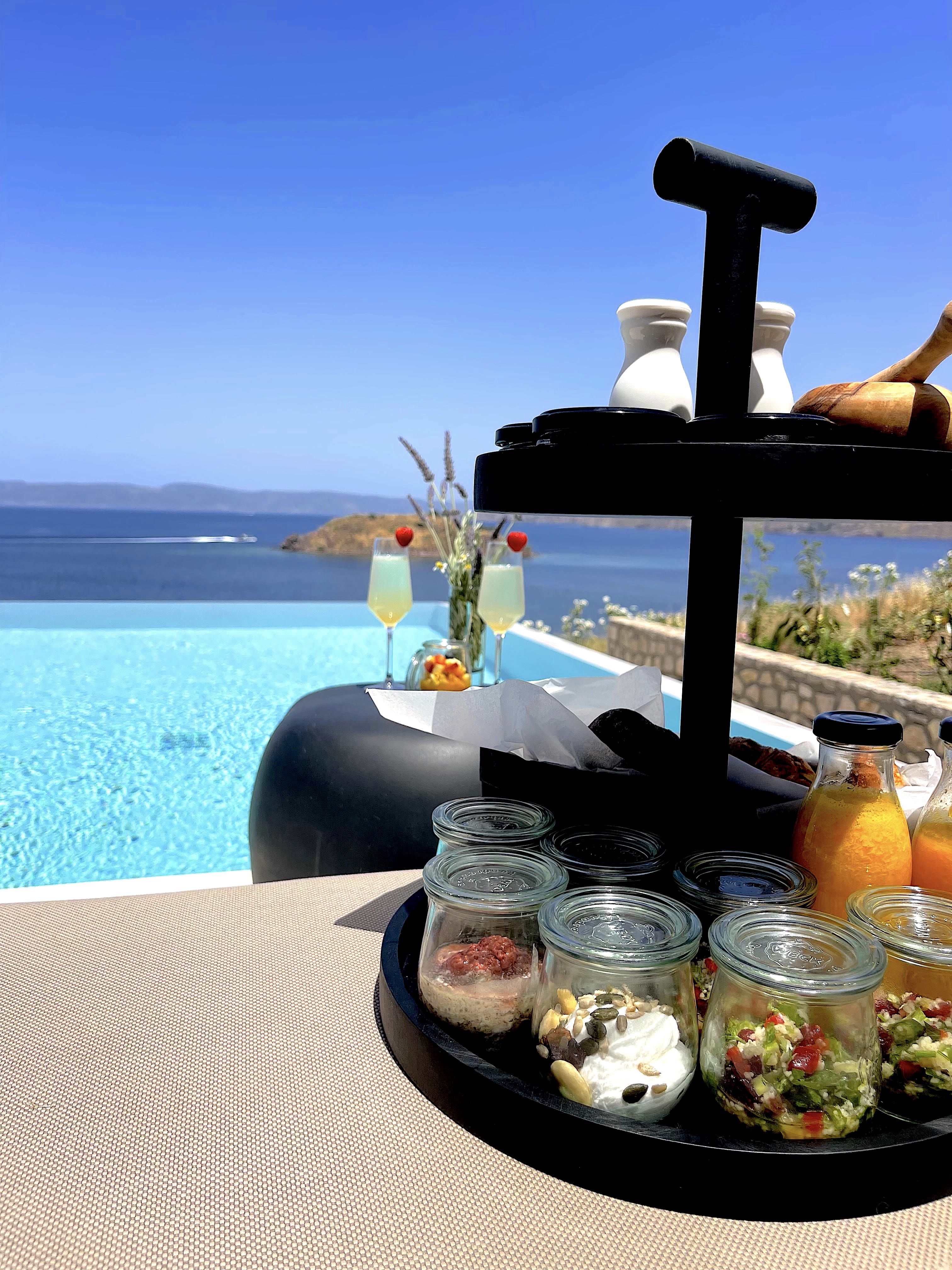 a table with food and drinks on it by a body of water