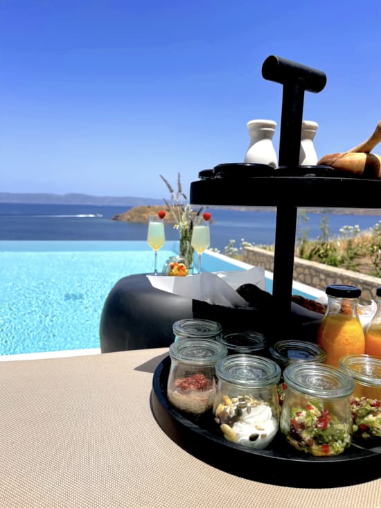 a table with food and drinks on it by a body of water