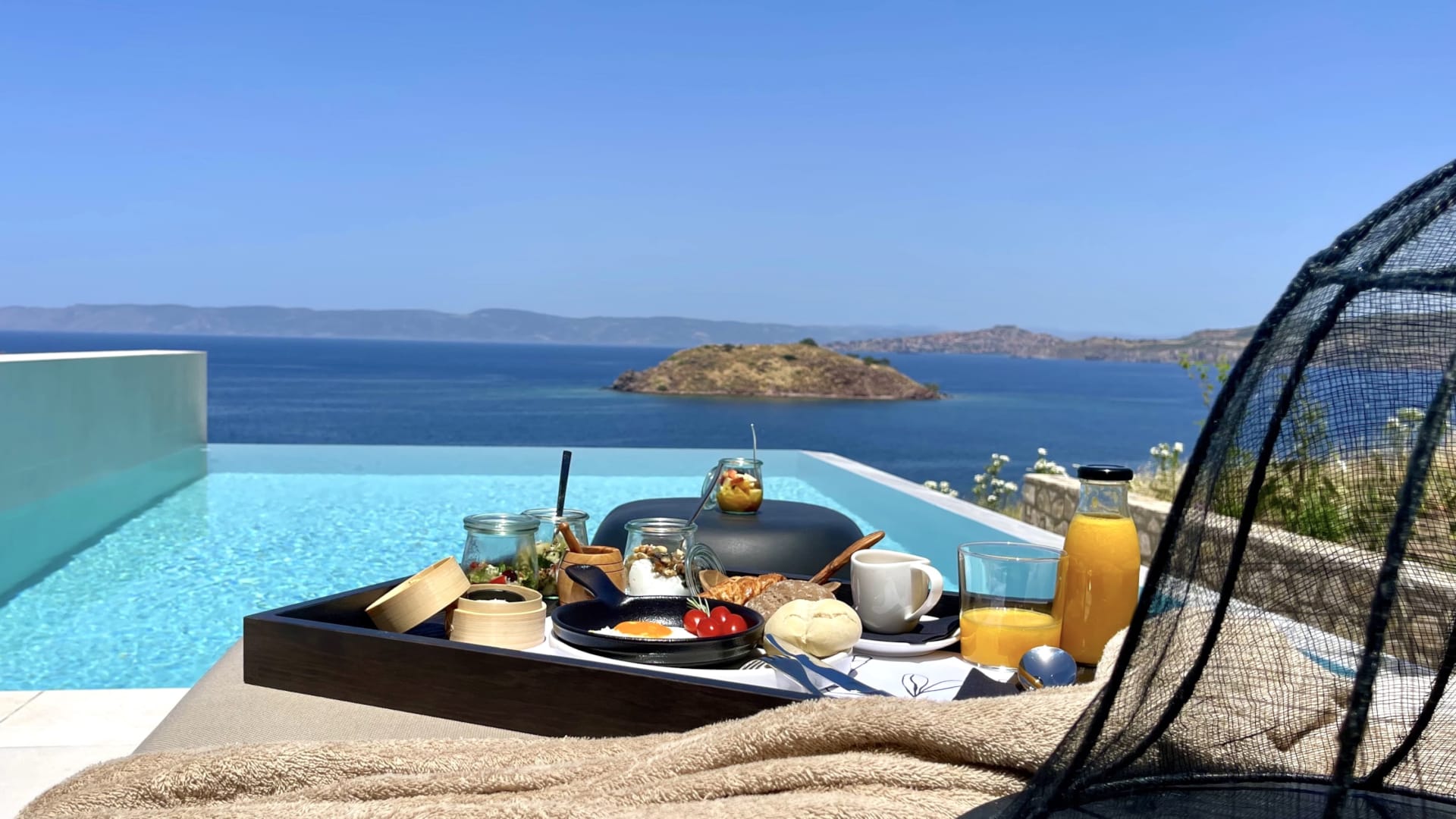 a table with food and drinks on it by a body of water
