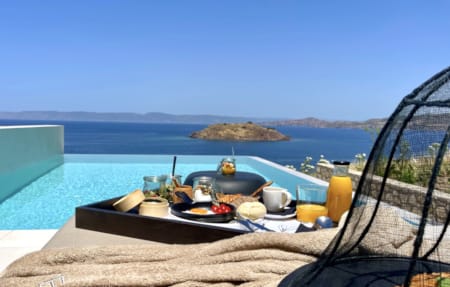 a table with food and drinks on it by a body of water