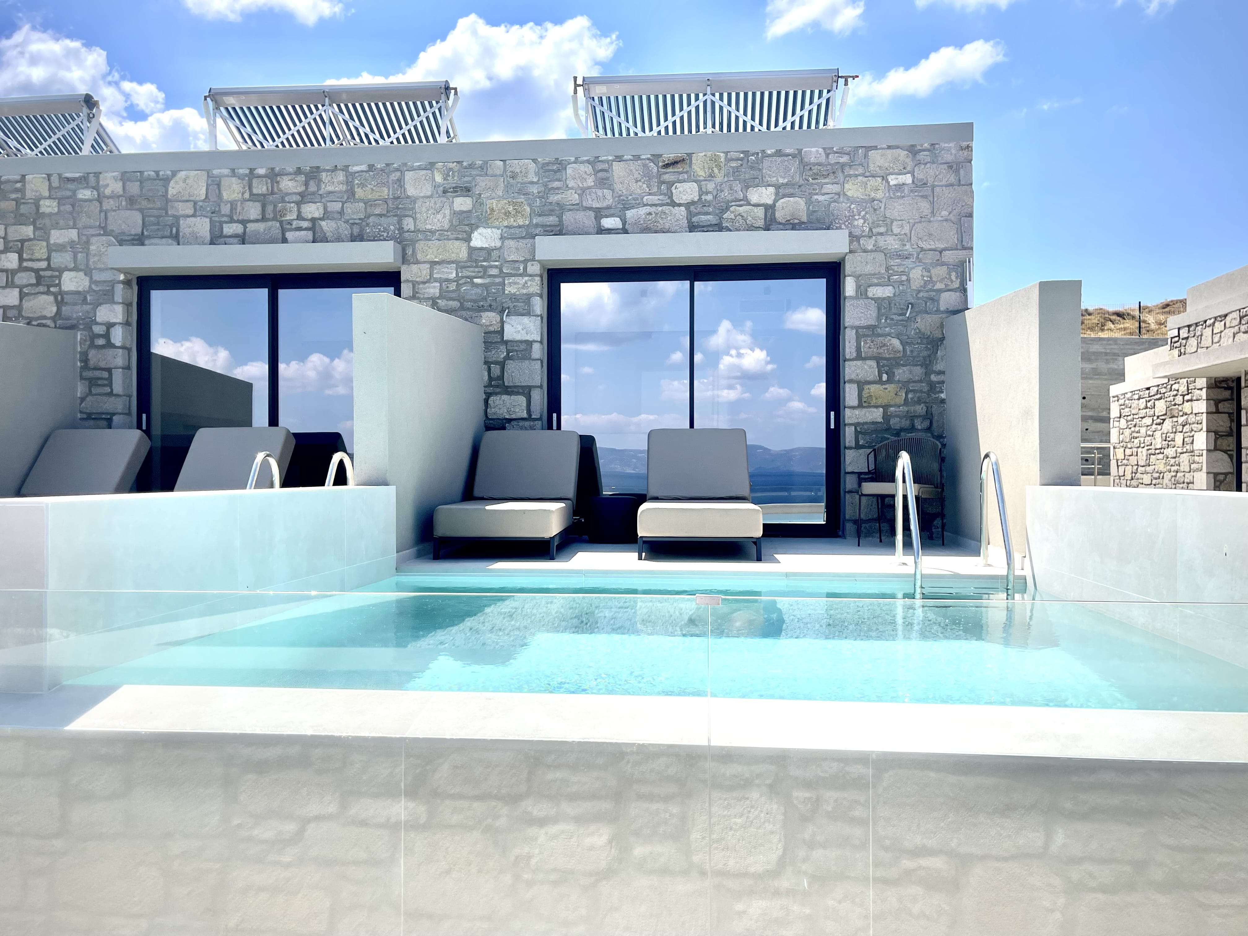 a swimming pool with a large glass wall and a large building with a large glass wall