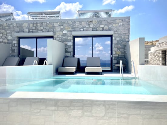 a swimming pool with a large glass wall and a large building with a large glass wall