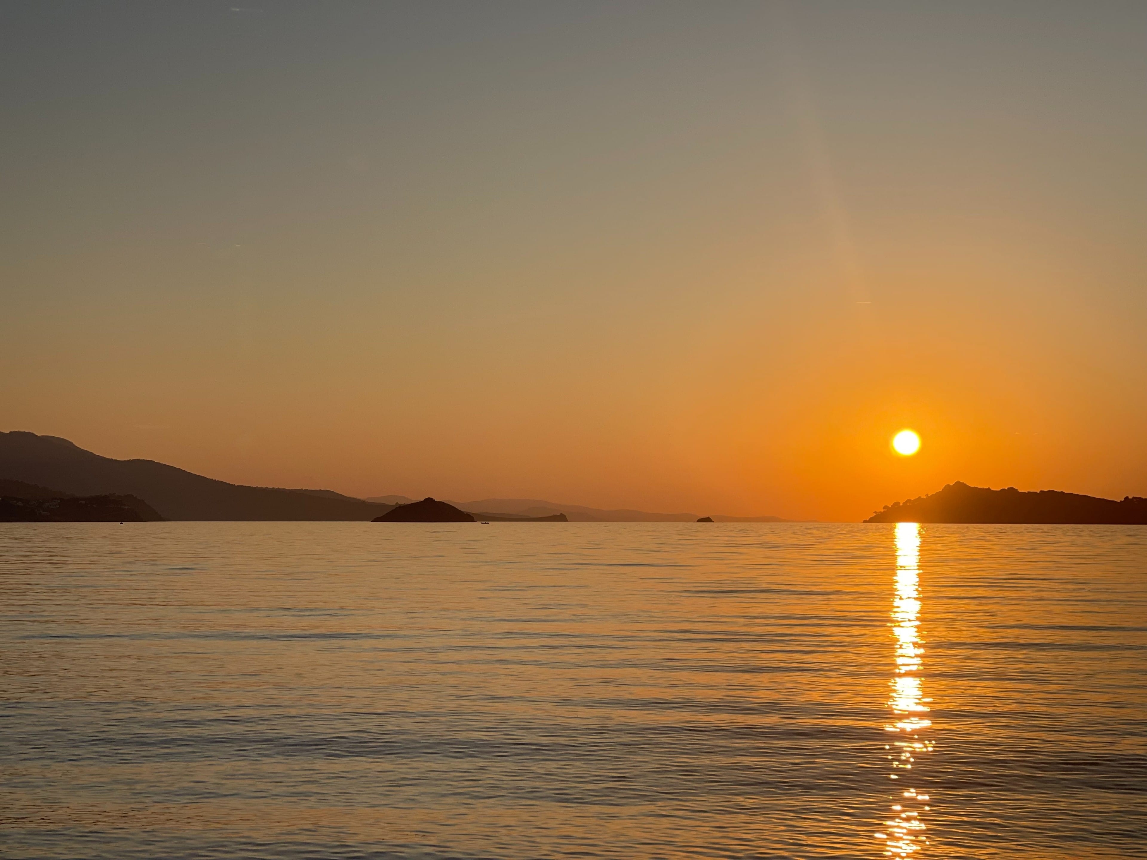 a sunset over a body of water