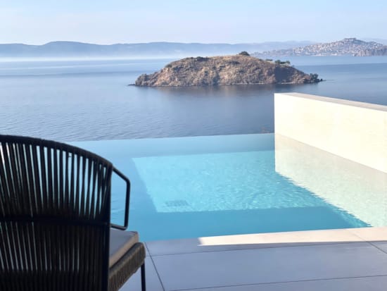 a pool on a deck overlooking the ocean