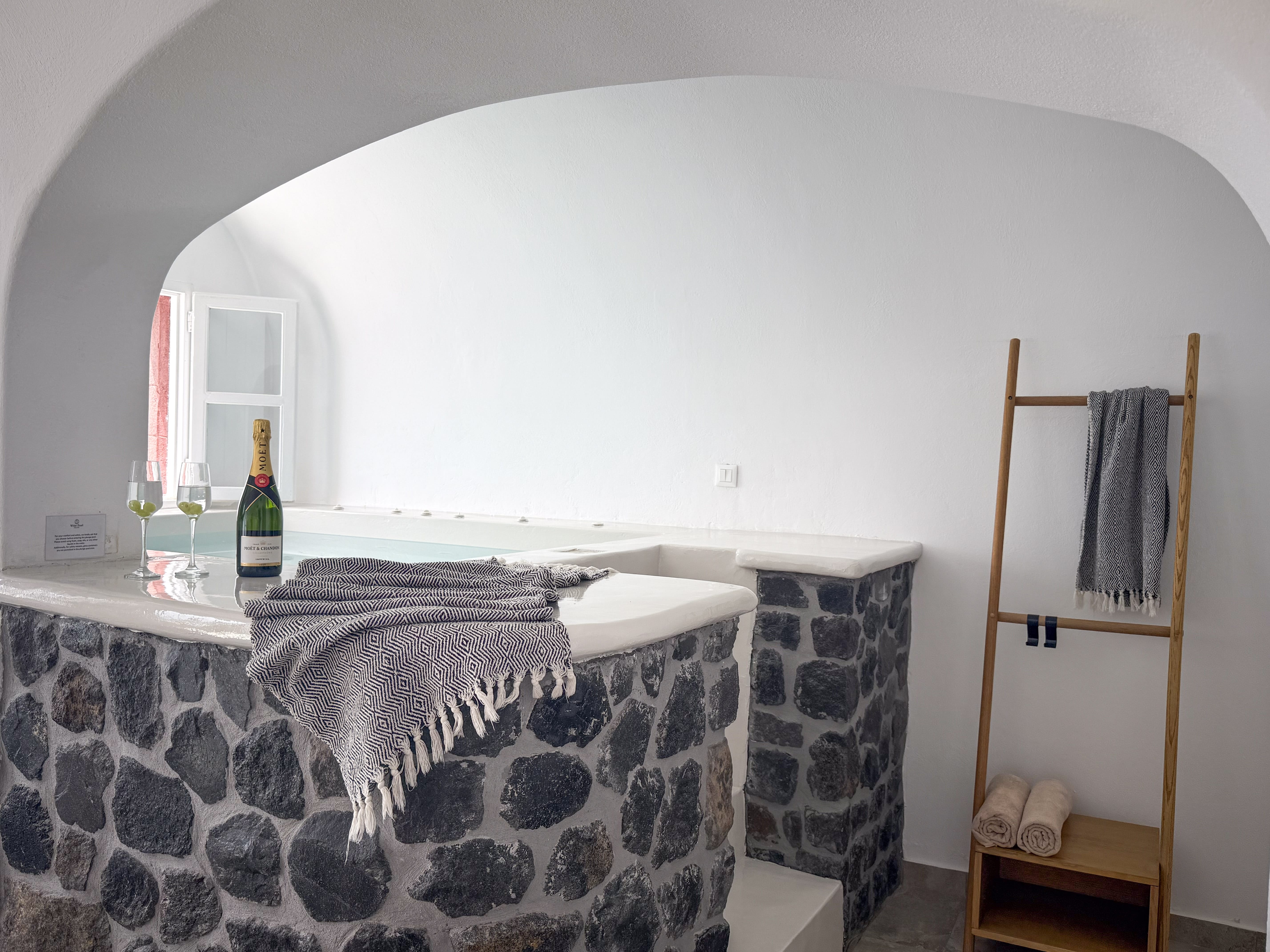 a bed with a bottle of wine on it