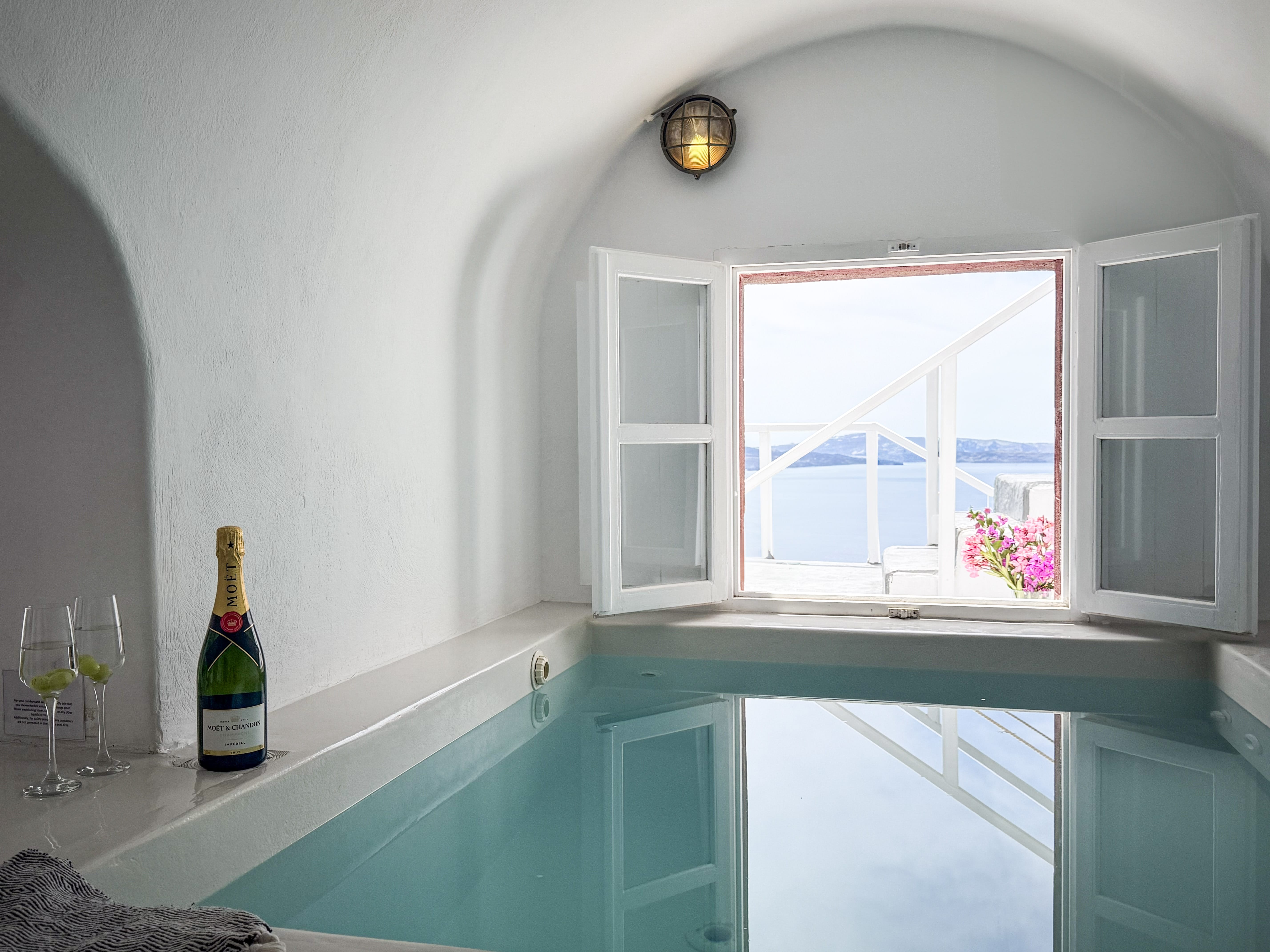 a bottle of wine on a window sill