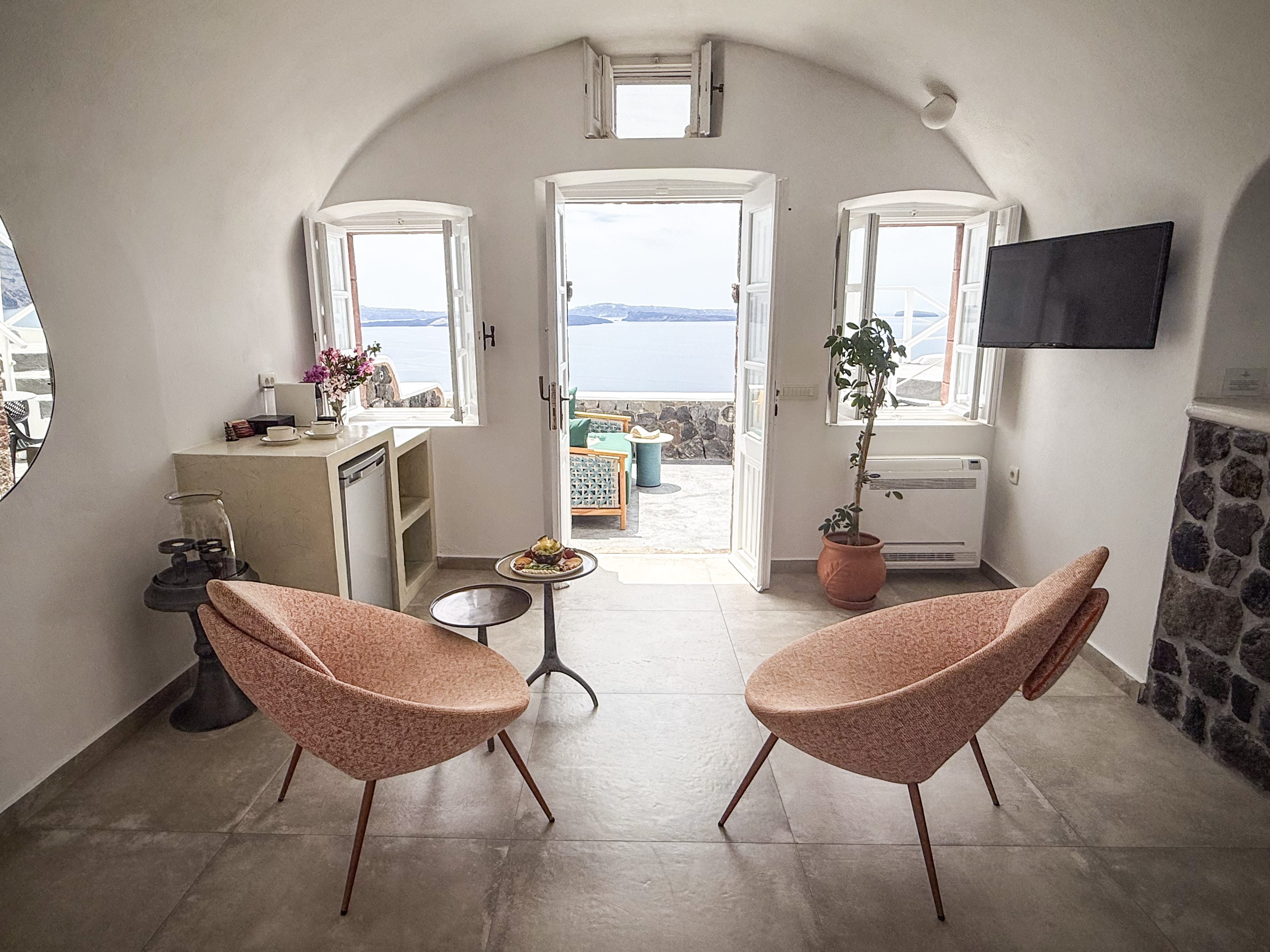 a living room with a couple of chairs and a table