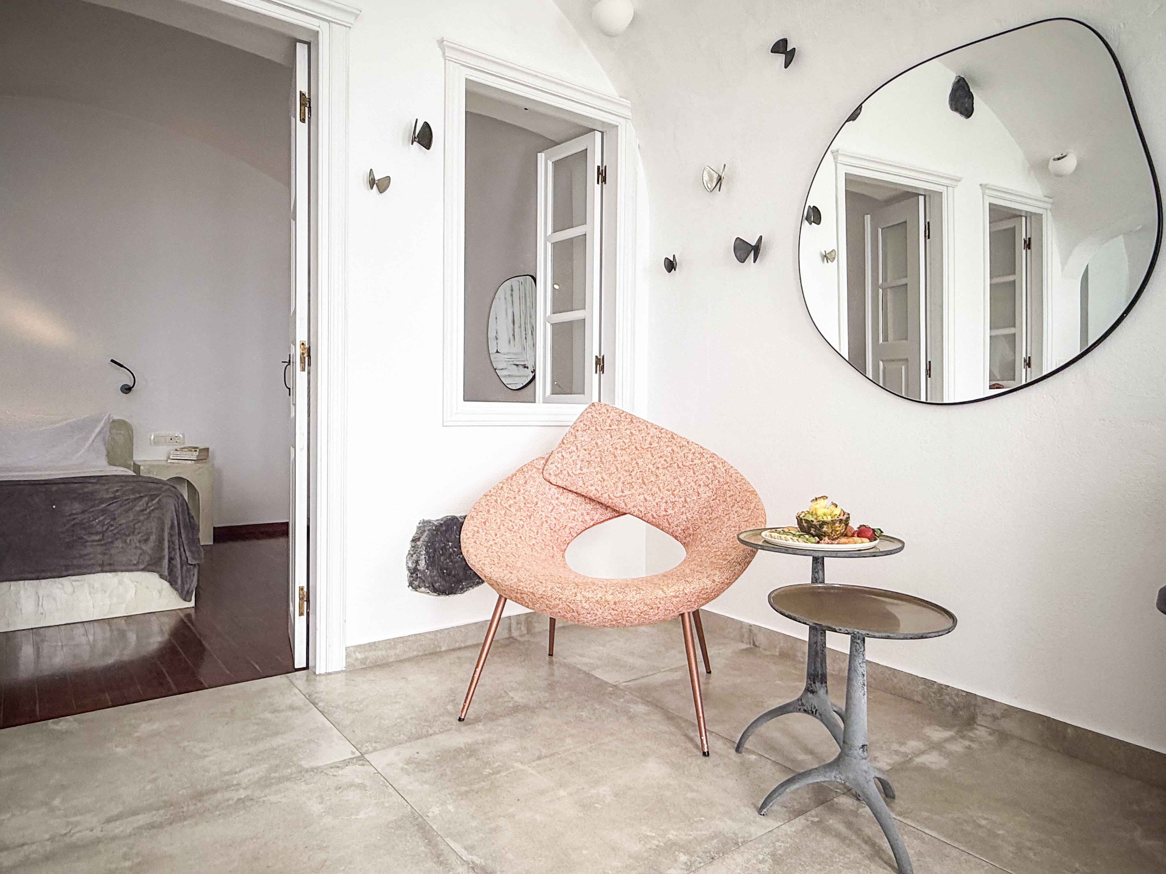 a room with a mirror and a chair