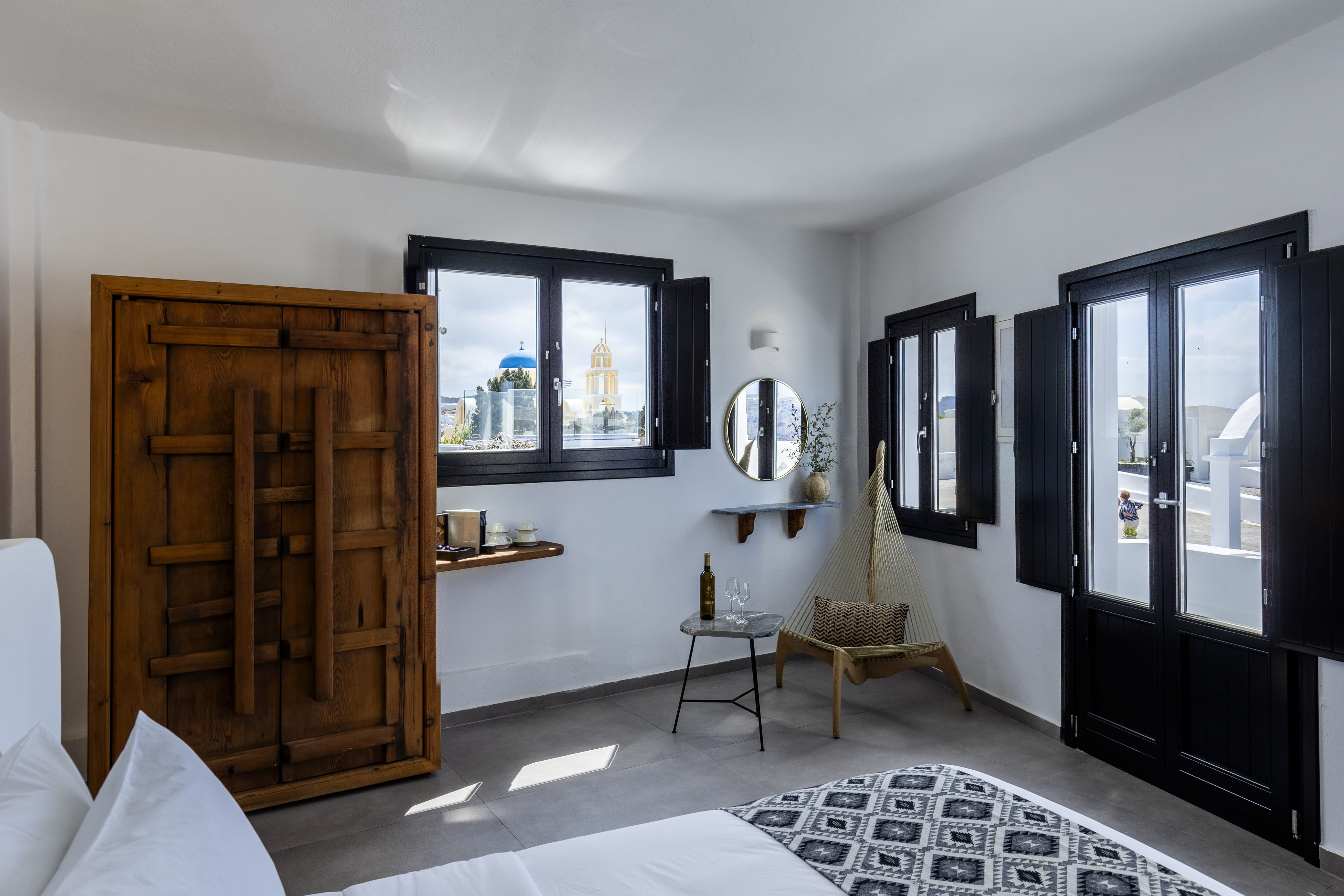 a room with a wood door and a white rug