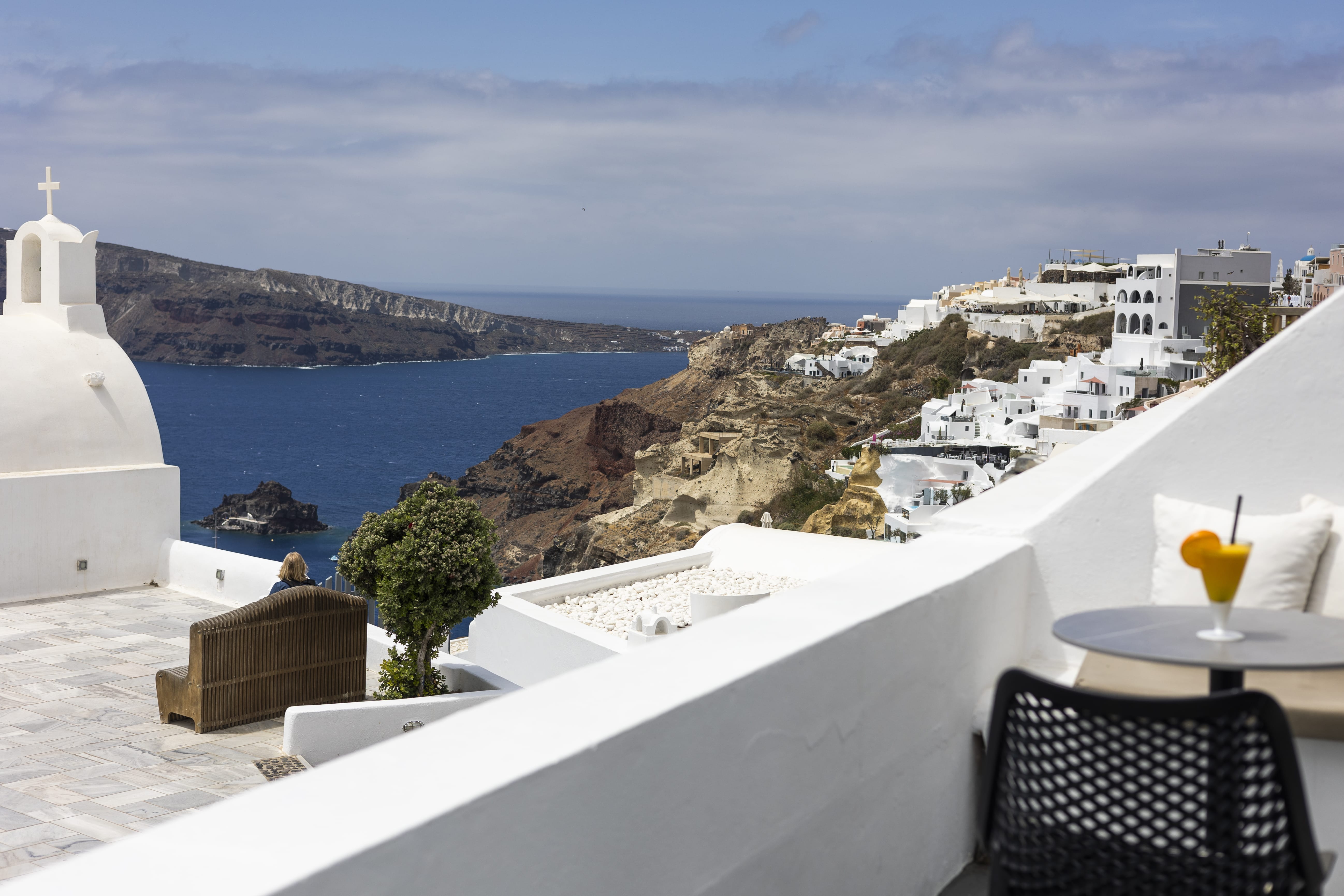 a view of a city and the ocean from a balcony