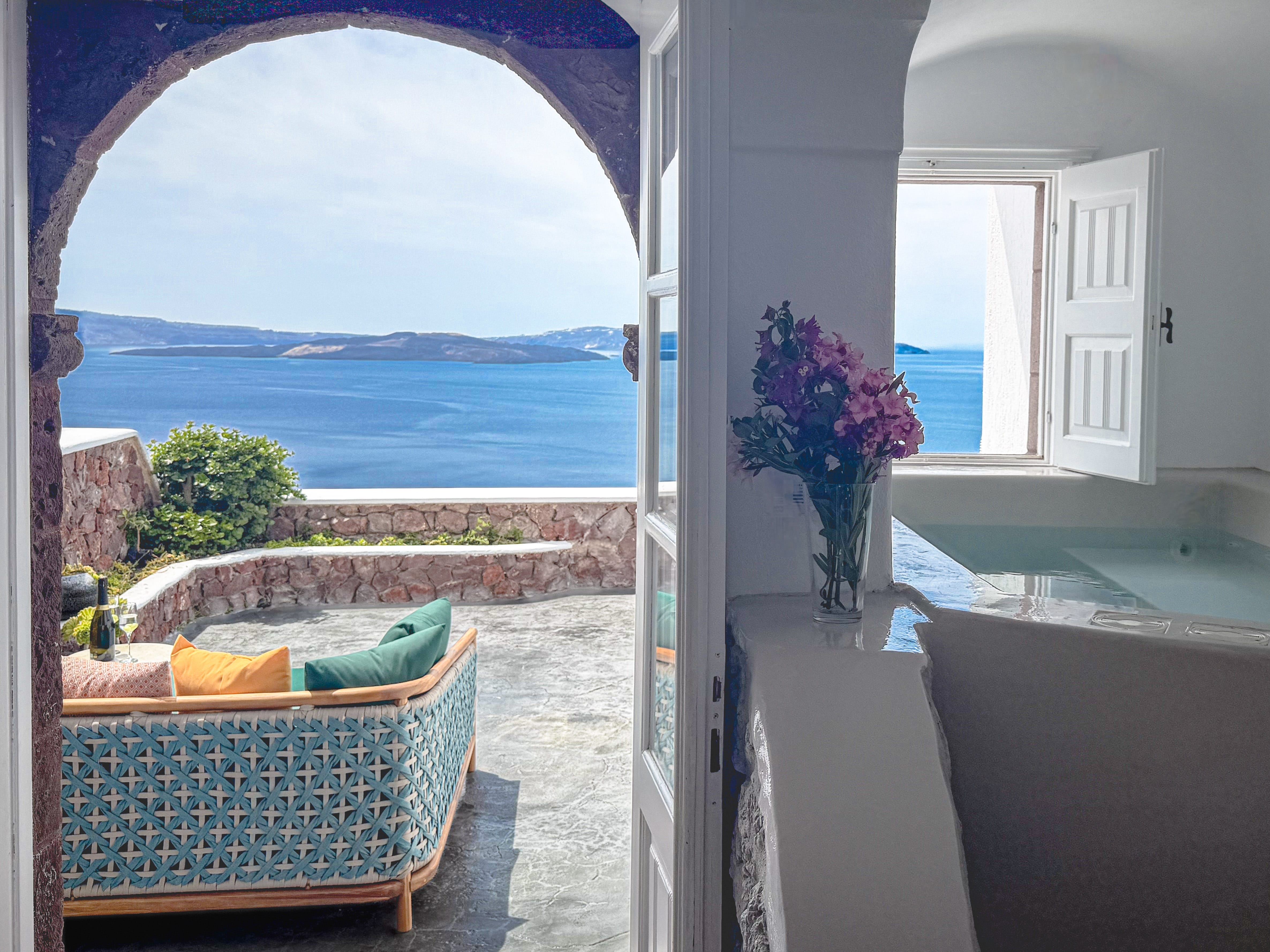 a pool and a chair in a room with a view of the ocean