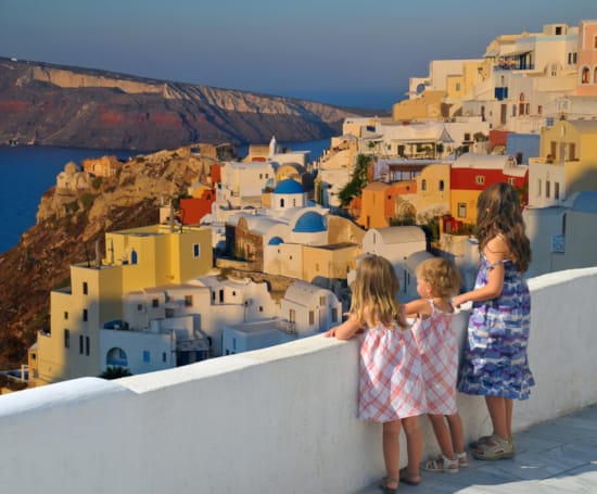 a group of children looking at a town