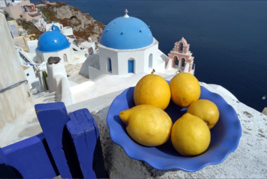 a plate of lemons on a balcony