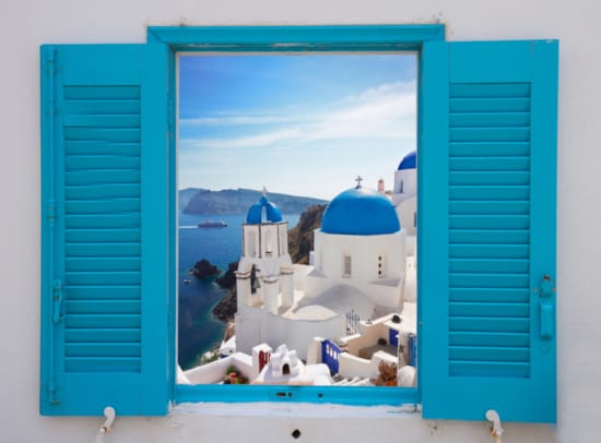 a blue door with a white building and blue doors