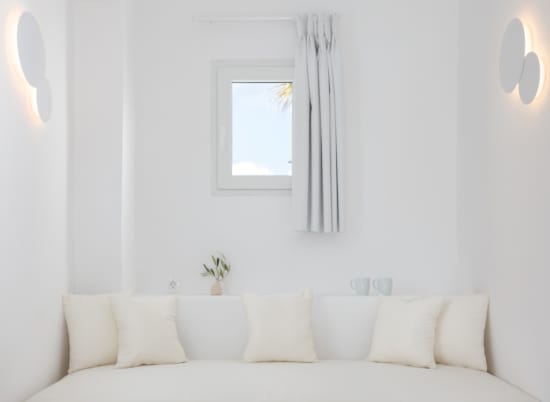 a white couch with a white wall