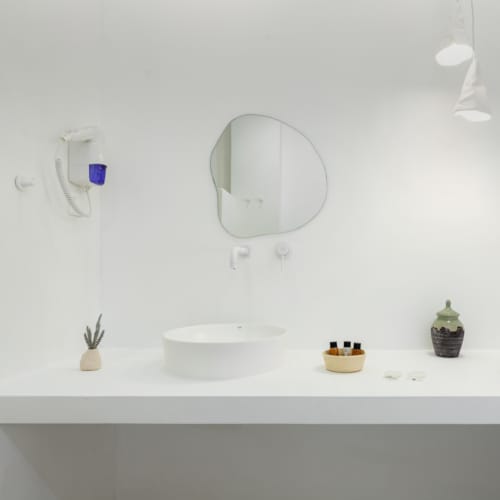 a bathroom with a mirror and sink