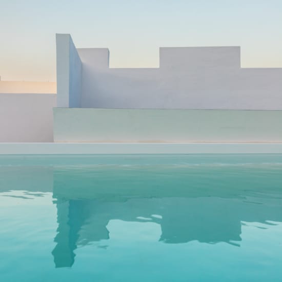 a large building with a pool in front of it