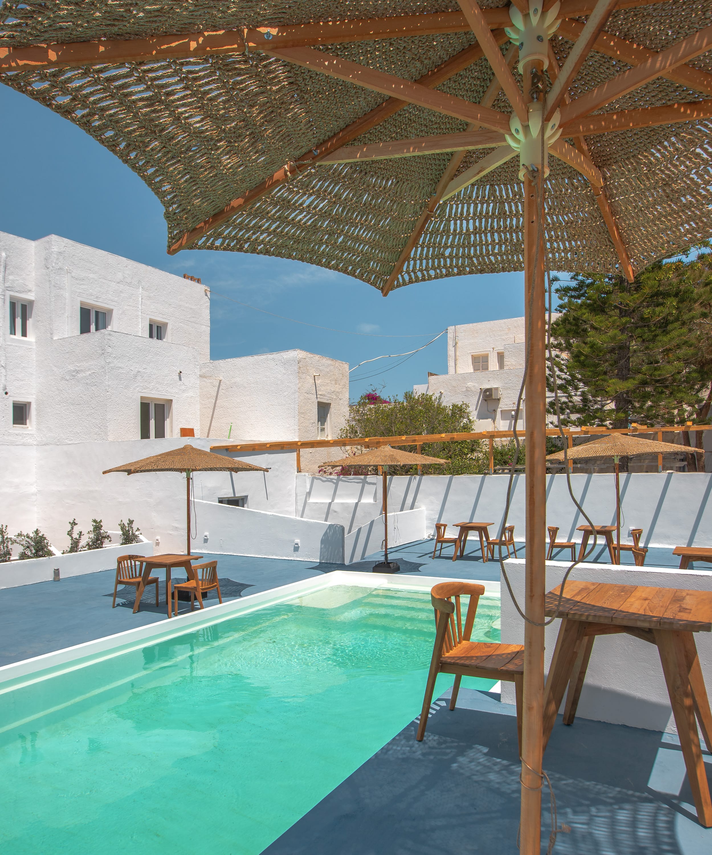 a pool with chairs and umbrellas