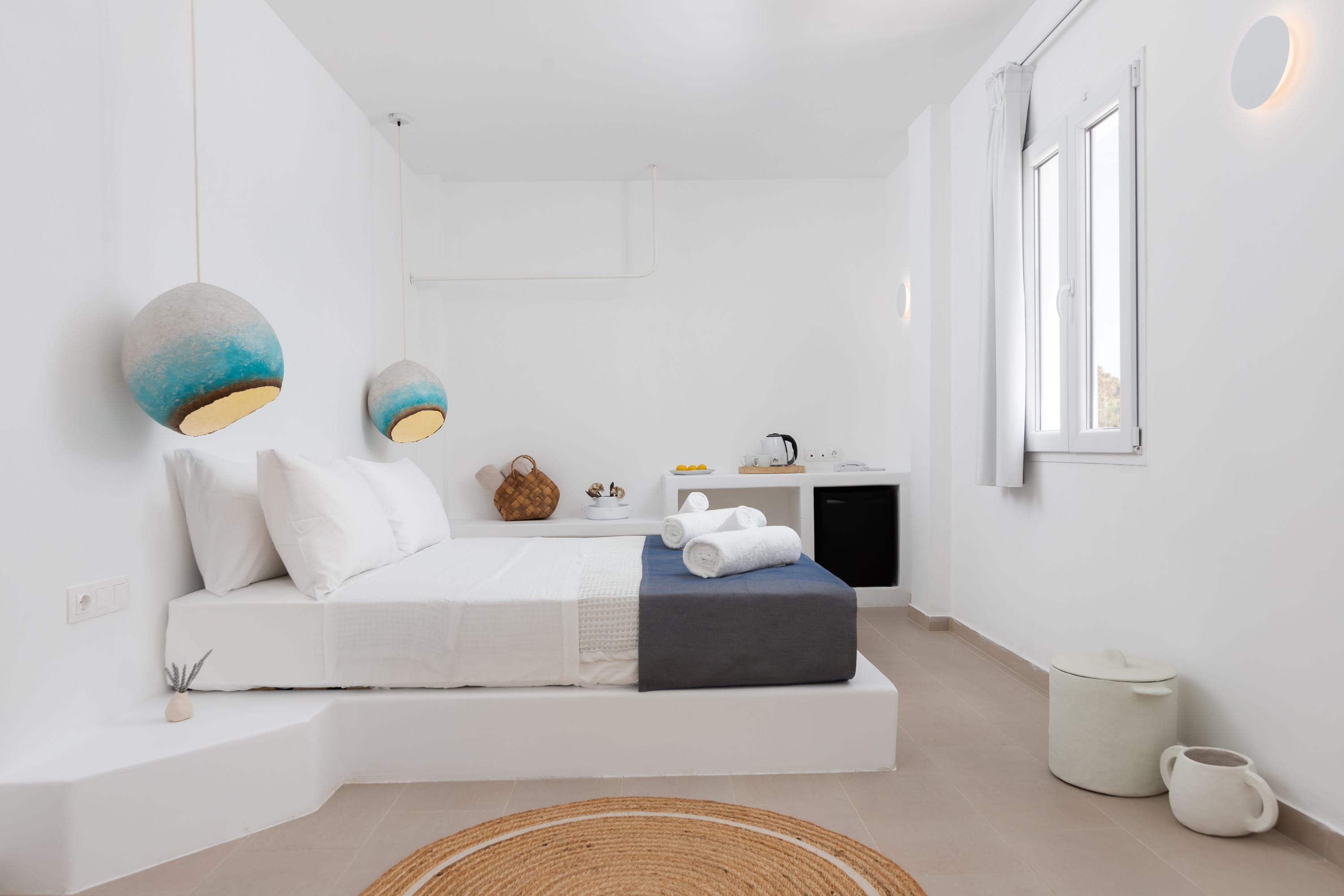 a white bathroom with a tub and a couch