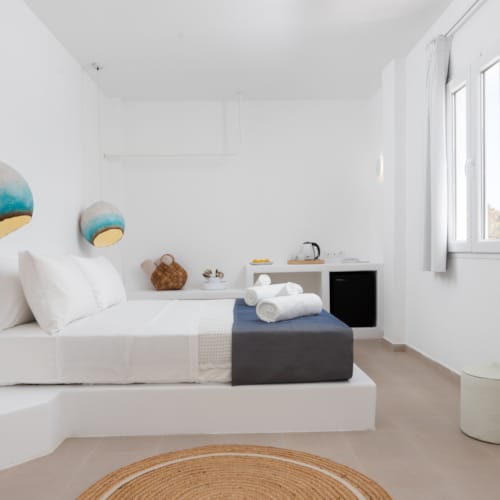 a white bathroom with a tub and a couch