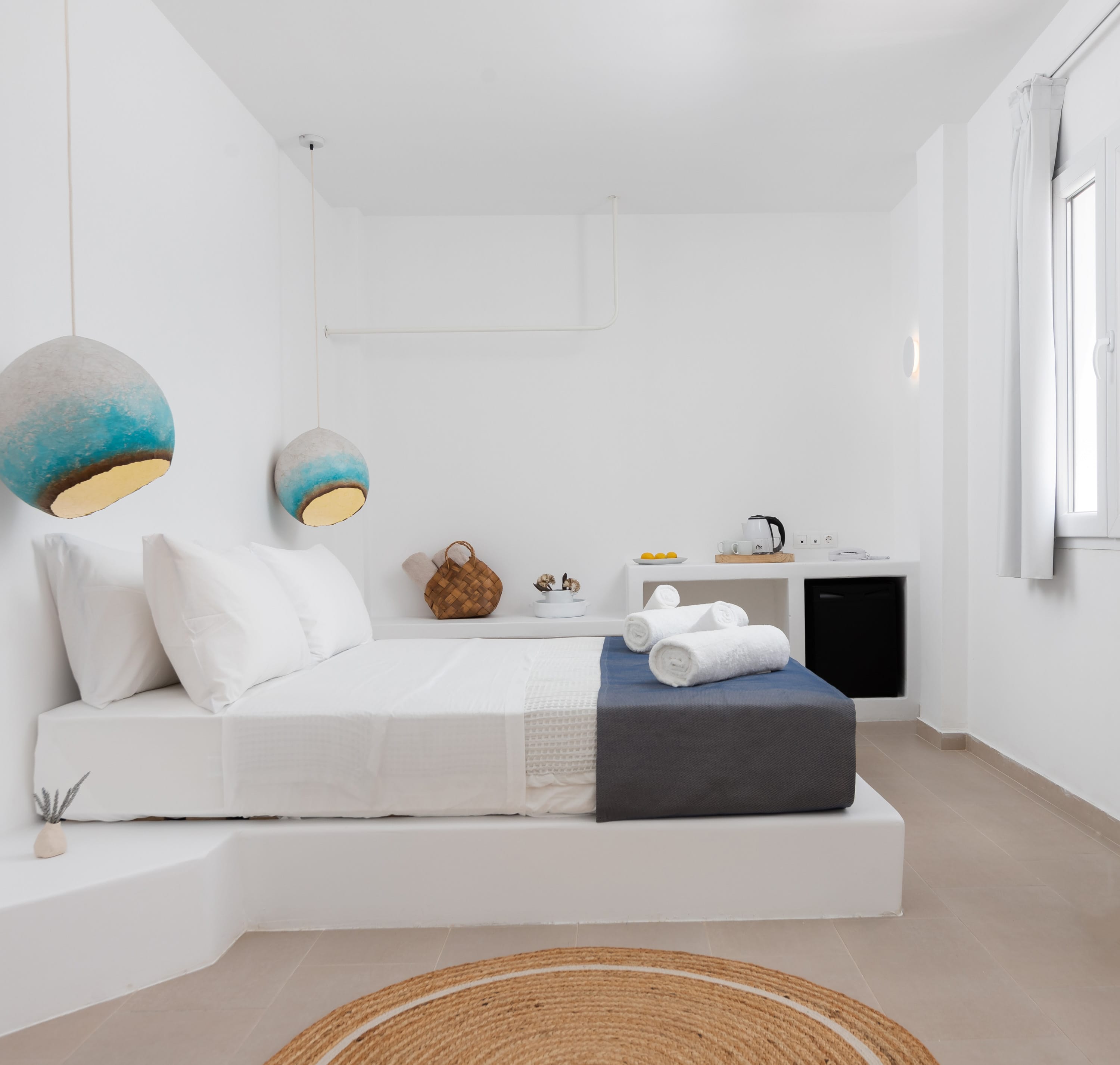 a white bed with a white bed and a white wall