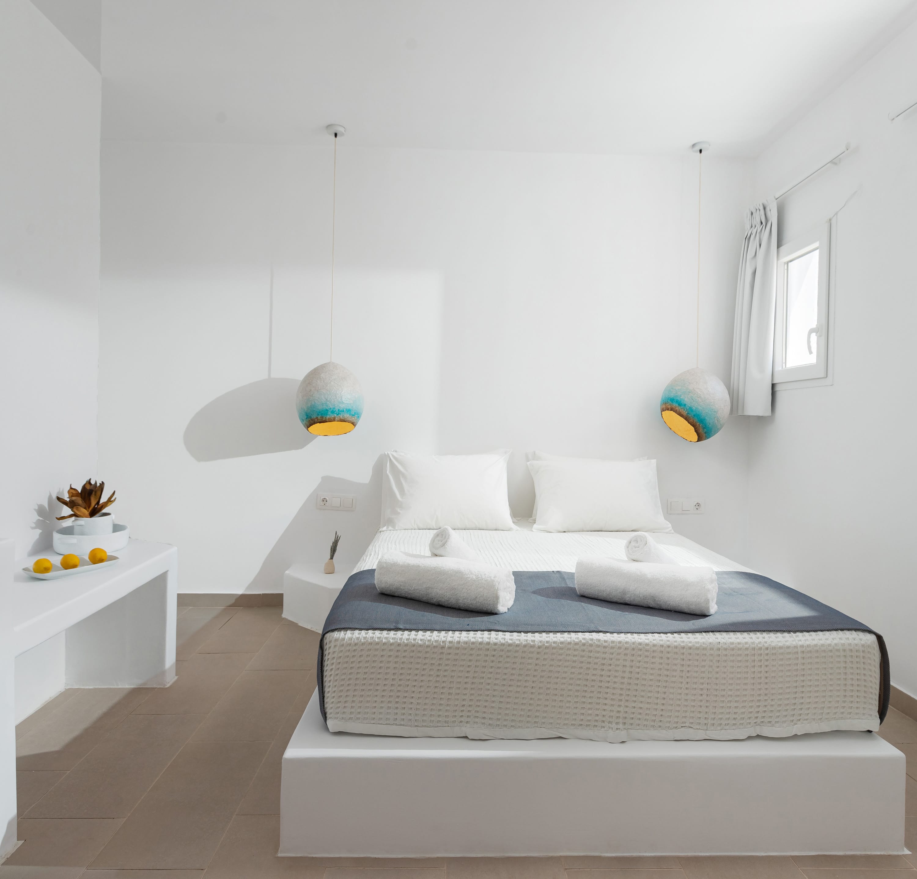 a bed with a white bed and a white table