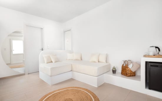 a white living room with a white couch and a white wall