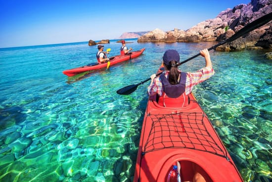 a group of people in kayaks on a river