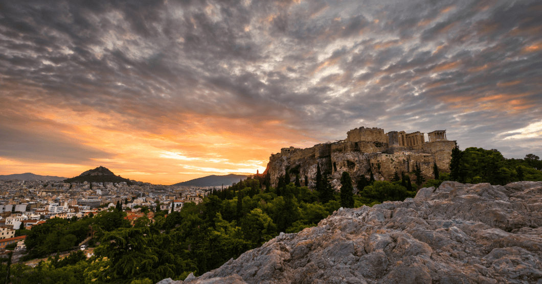 a landscape with a hill and buildings