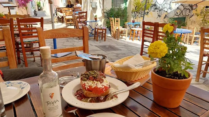 a table with plates of food and a bottle of water