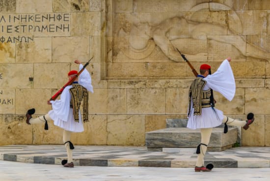 a group of people in clothing walking down a street