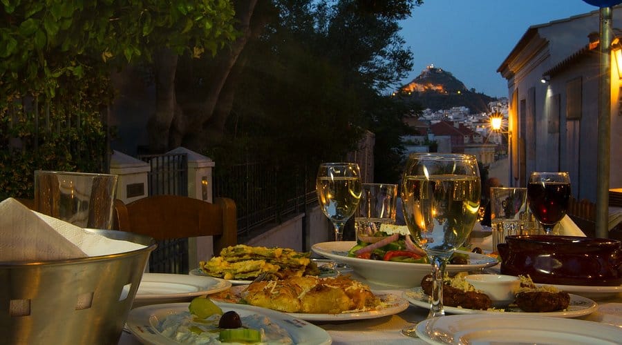 a table with food and wine glasses