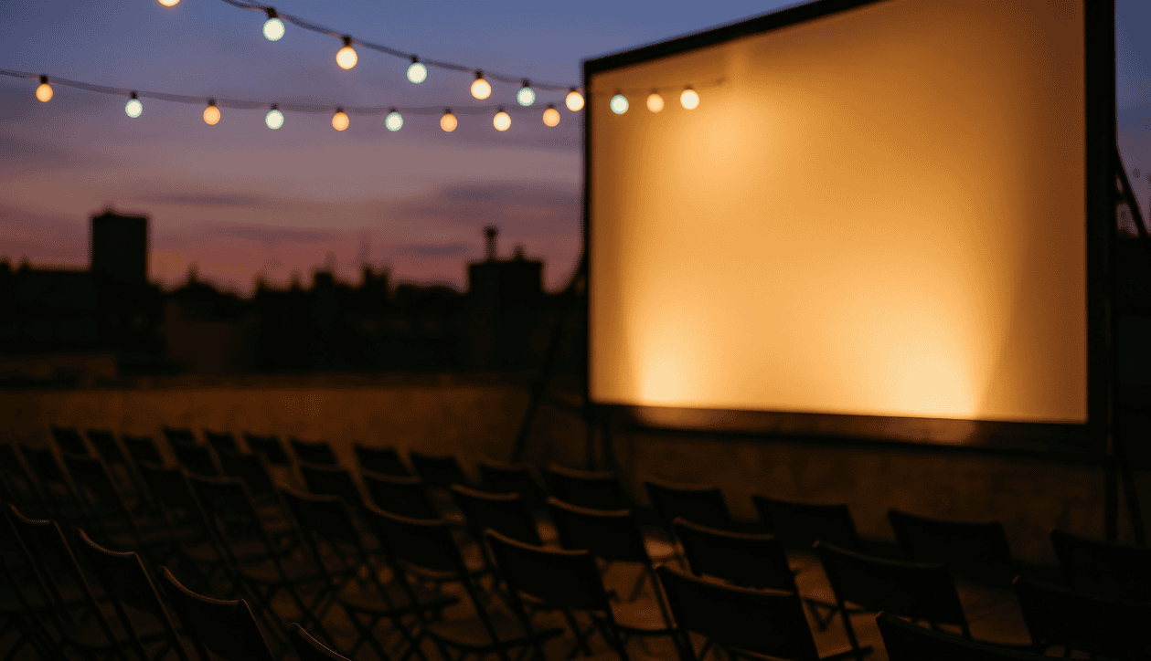a large room with rows of chairs and a stage with lights