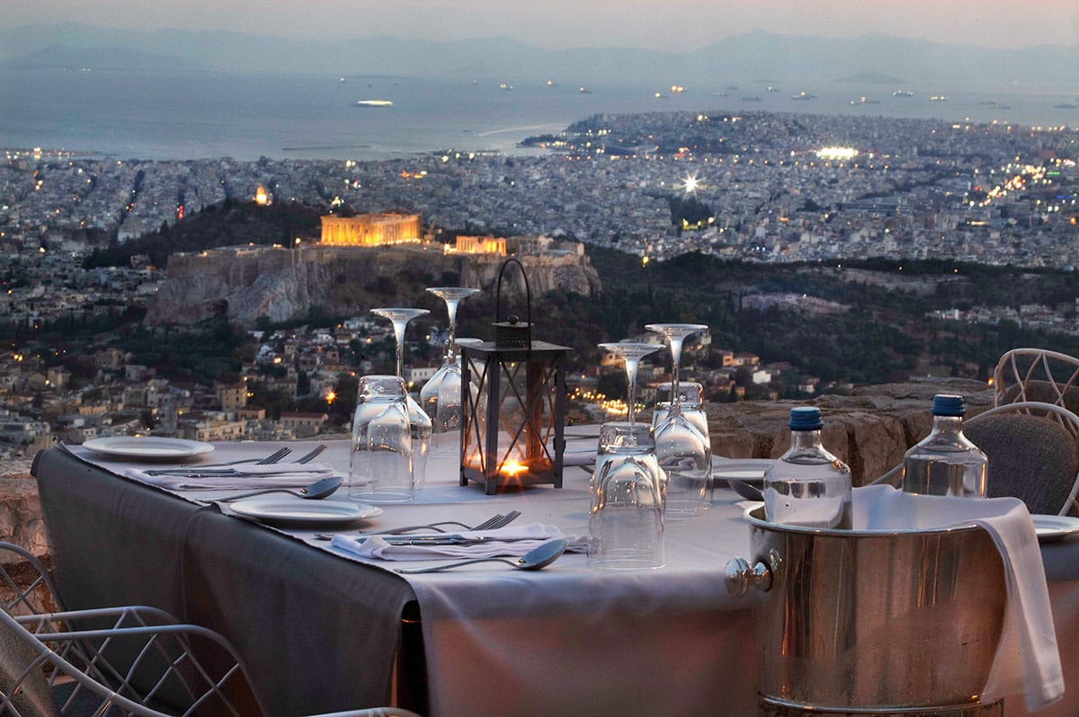 a table with a view of a city and the water