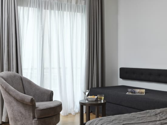 a room with a chair and a table with a glass on it